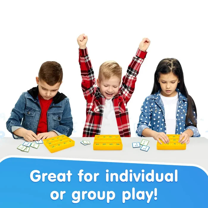 Three kids use yellow poppable bingo boards and math tiles. A boy cheers. Text: Great for individual or group play!