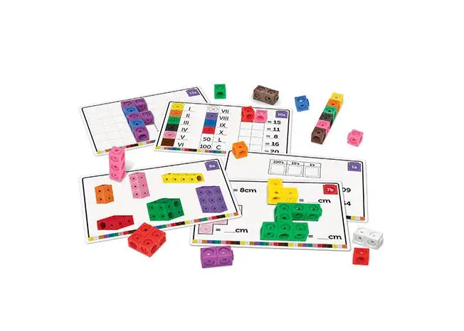 Multi-colored interlocking cubes and educational activity cards with math grids, numbers, and Roman numerals.