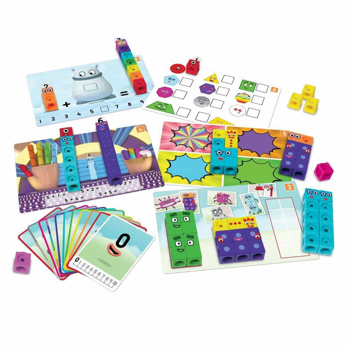 Colorful linking cubes with Numberblocks character faces, math activity mats, and number cards.