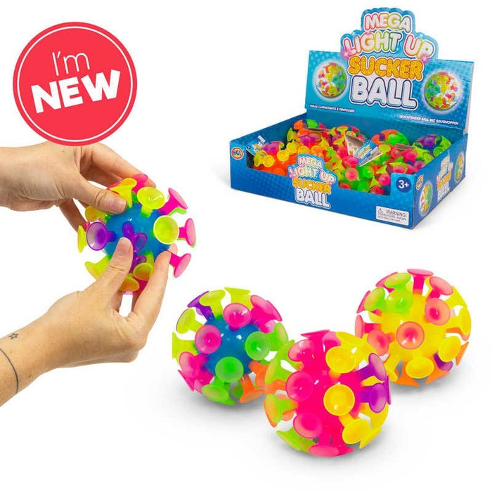Brightly colored balls with suction cups in a blue display box and being held by hands to show texture and size.