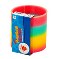 Coiled plastic toy with a rainbow color gradient, partially wrapped in blue cardboard retail packaging.