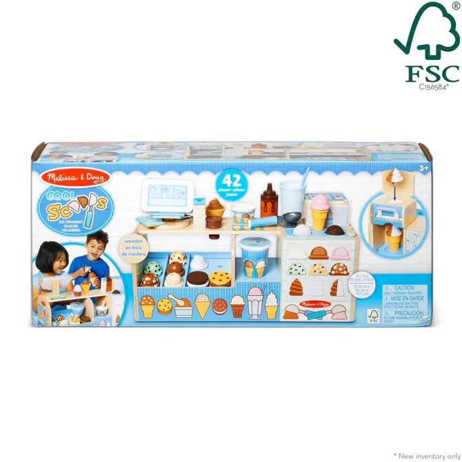 Boxed 42-piece wooden ice cream shop toy with colorful scoops, cones, and a soft-serve machine on a white play counter.