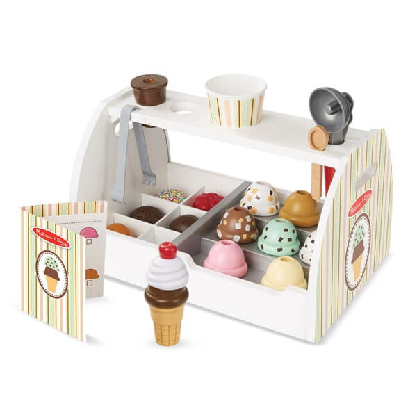 White wooden toy ice cream counter with colorful scoops, toppings, cones, and accessories.