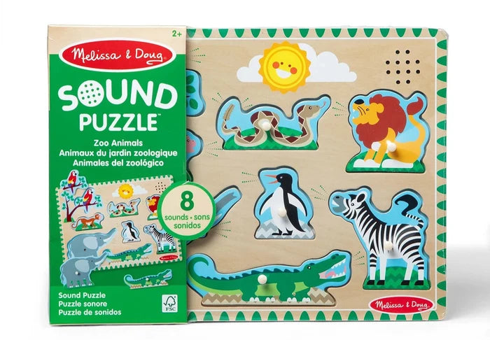 Wooden sound puzzle with 8 peg-handle animal pieces including a lion, zebra, and crocodile on a light board.