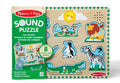 Wooden sound puzzle with 8 peg-handle animal pieces including a lion, zebra, and crocodile on a light board.