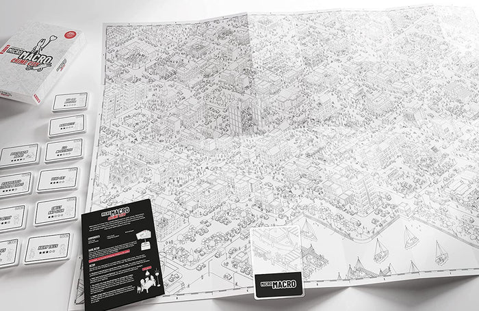 Large black and white isometric city map shown with a white game box, game cards, and an instruction manual.