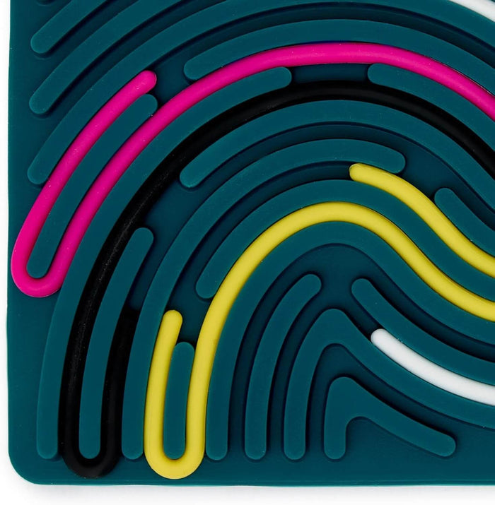 Teal silicone sensory board close-up showing flexible, raised paths in vibrant pink, yellow, black, and white.