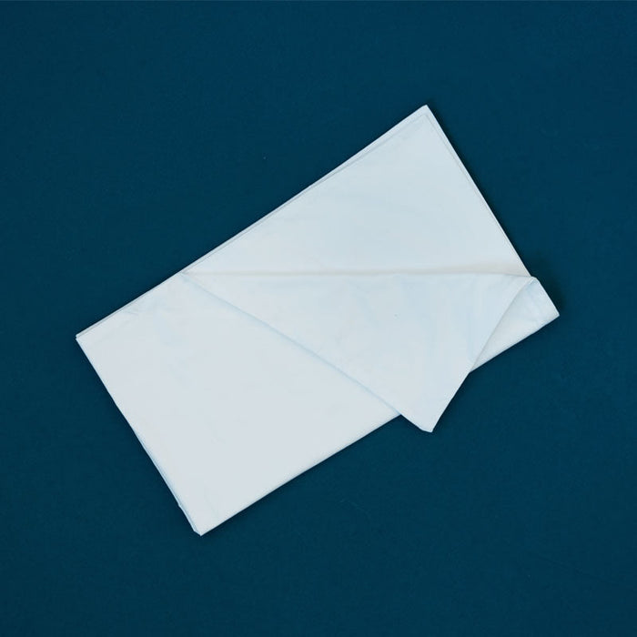 Folded MiteGuard pillow cover in standard size, made of protective fabric, shown partially unfolded on a clean surface.