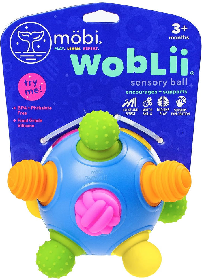 Blue sensory ball with colorful, textured silicone nubs in green, pink, and orange, shown on its blue retail packaging.