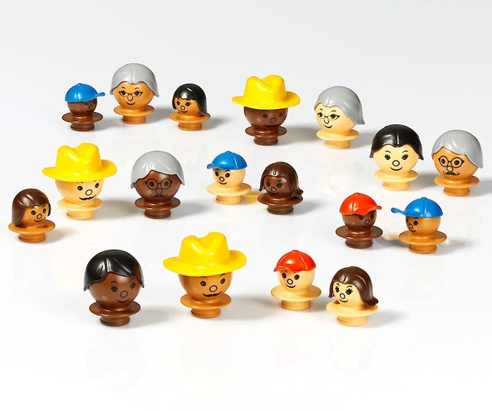 18 toy figure heads showing diverse skin tones, hair styles, and colorful hats like cowboy and baseball caps.