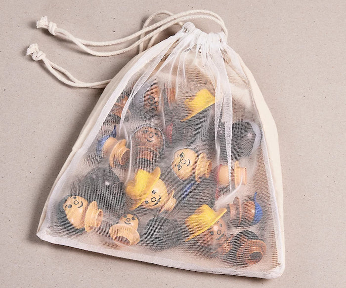 Diverse toy figurines with various skin tones, hair colors, and colorful hats inside a white mesh drawstring bag.