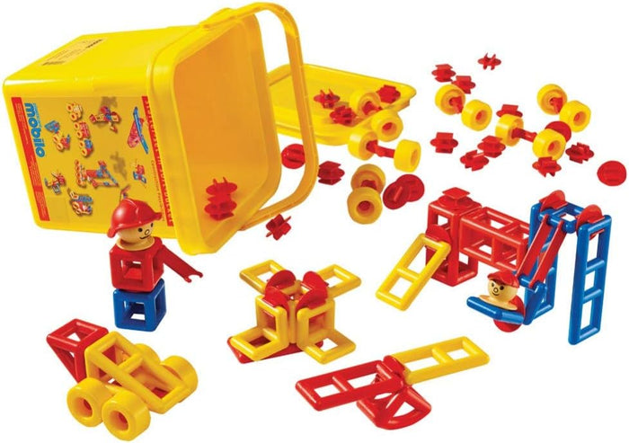Red, yellow, and blue plastic building pieces spilling from a yellow storage bucket with assembled toy figures.