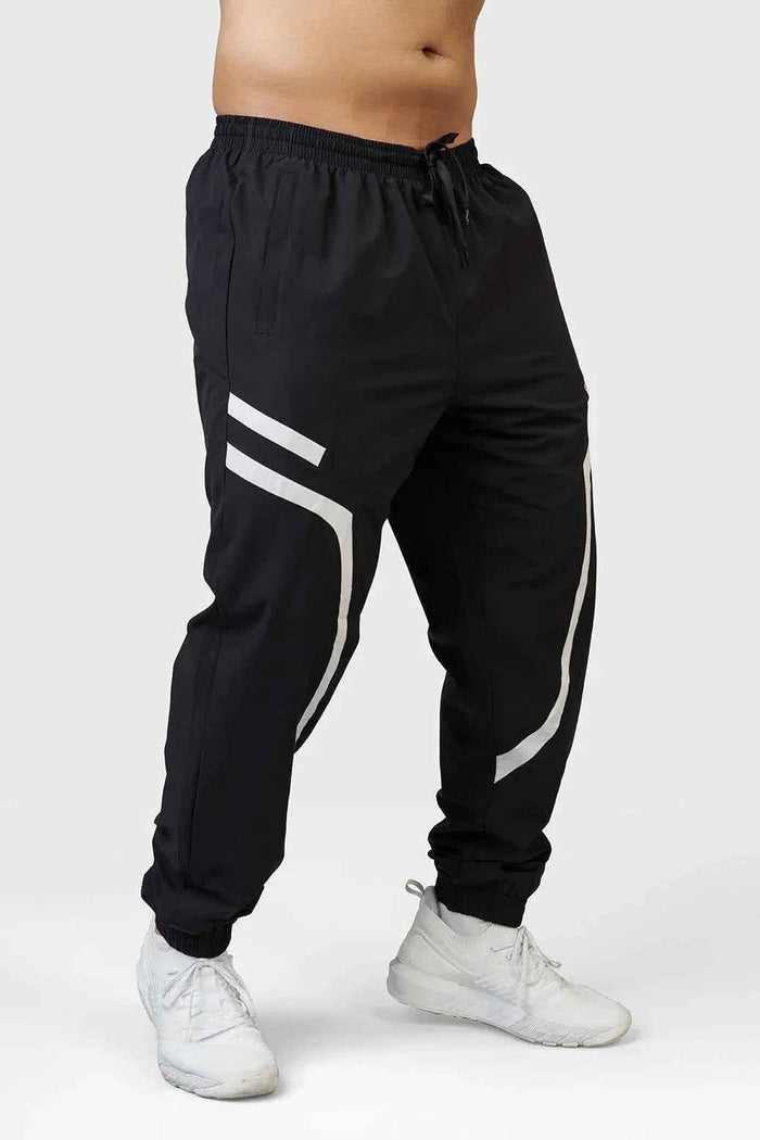 Black Fuaark Nz Momentum Joggers, casual athletic pants with a relaxed fit and comfortable waistband, shown on a model.