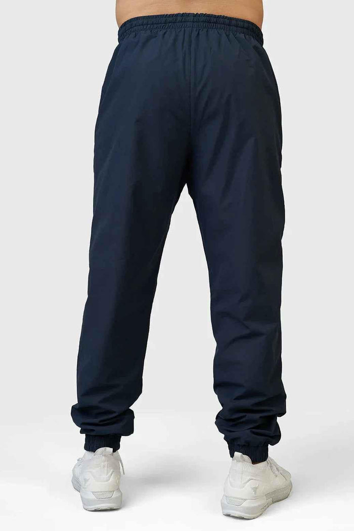 Navy Fuaark Nz Momentum Joggers laid flat showing elastic waistband and tapered fit, ideal for casual wear and workouts.