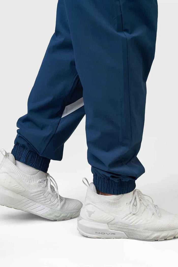 Fuaark Nz Momentum Joggers in teal color, casual athletic pants with an elastic waistband and tapered fit.