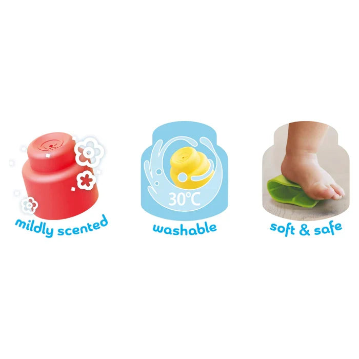 Three icons: a scented red block, a washable yellow block, and a baby stepping on a soft green block.