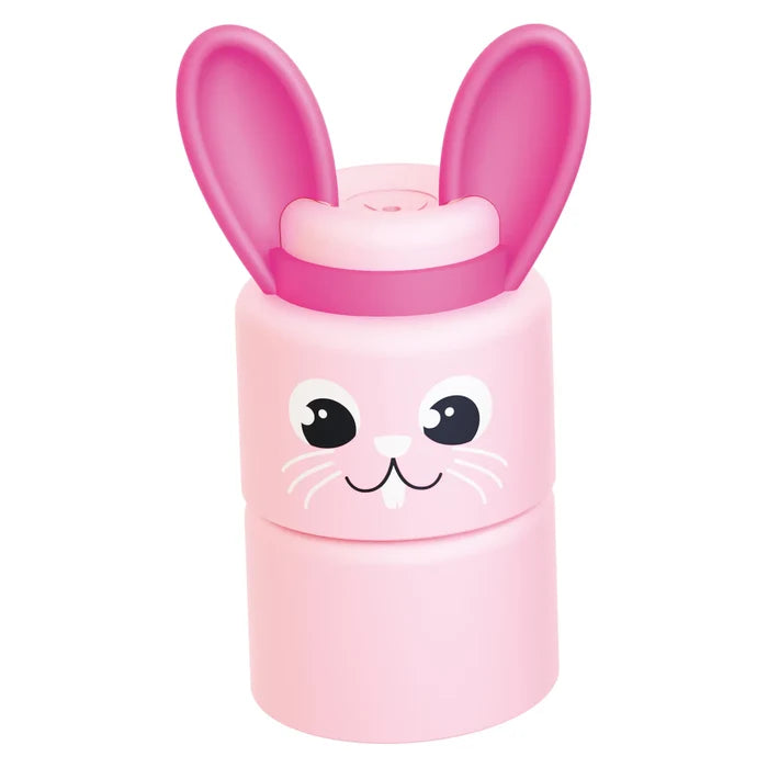 Light pink cylindrical bunny toy with tall hot pink ears and a cute cartoon face with black eyes and white whiskers.