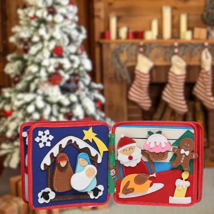 Open red felt book with nativity scene, Santa, gingerbread man, and turkey against a blurred Christmas background.