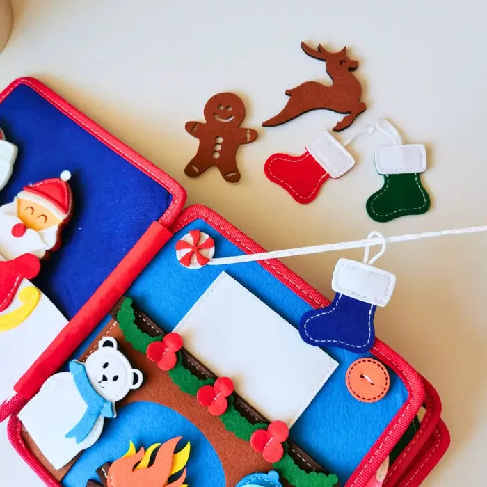 Felt Christmas activity book with Santa, polar bear, and detachable gingerbread man, reindeer, and stocking pieces.