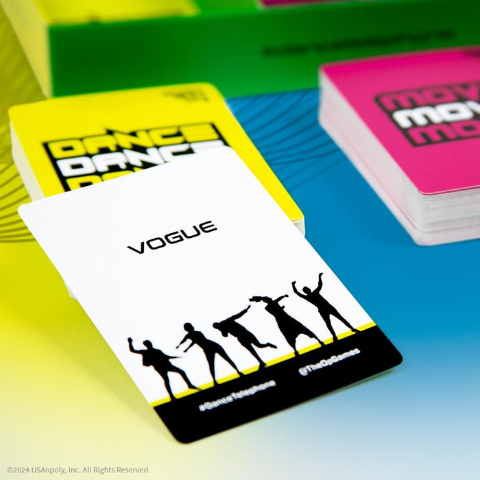 White game card with VOGUE and dancing silhouettes in front of yellow and pink card stacks on a blue surface.