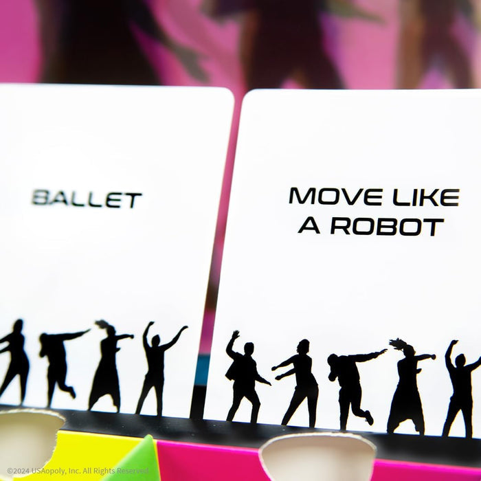 Two white game cards reading BALLET and MOVE LIKE A ROBOT above black silhouettes of people dancing.