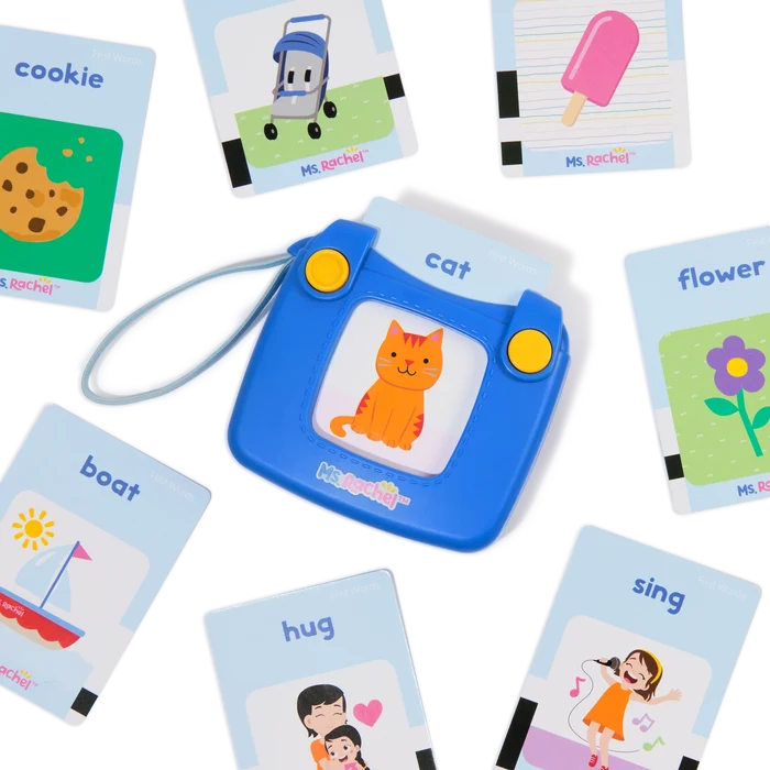 Blue electronic toy reader surrounded by colorful flashcards with illustrations of a cat, boat, and flower.