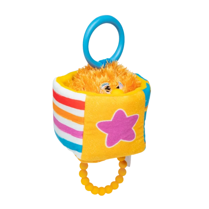 Plush sensory cube with an orange fuzzy monster, pink star, striped sides, blue ring, and yellow beaded teether.