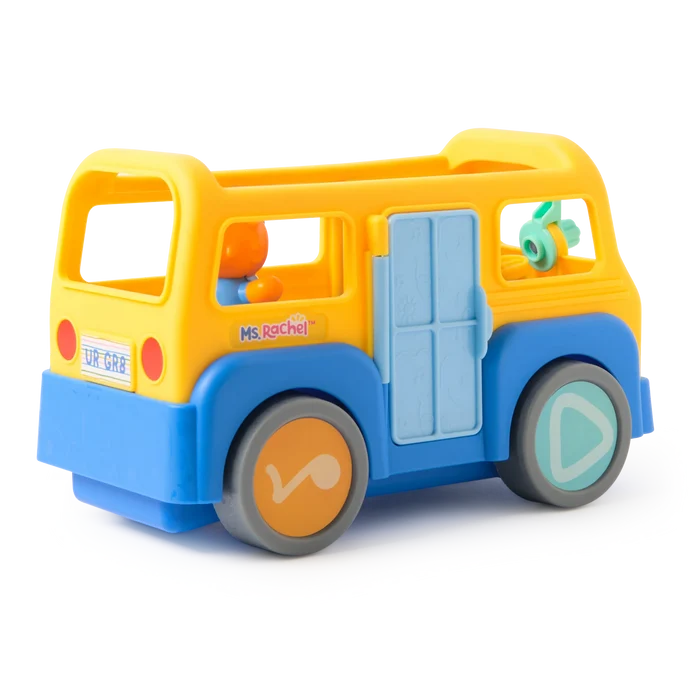 Yellow and blue plastic toy bus with Ms. Rachel branding, musical note wheels, and an orange character driver.
