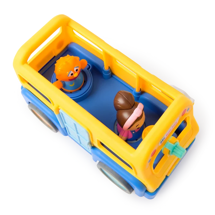 Yellow and blue open-top toy bus with an orange puppet and a girl character figure seated inside.