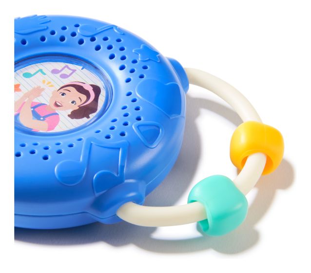 Blue circular toy radio with Ms. Rachel illustration, musical note patterns, and a white handle with yellow and teal beads.