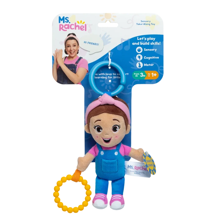 Small Ms. Rachel plush in blue overalls and pink shirt holding a yellow ring, on blue and white product packaging.