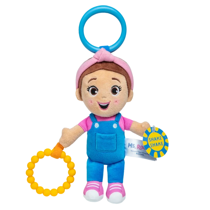 Plush Ms. Rachel toy in blue overalls, pink headband, blue hanging ring, yellow beaded ring, and SHAKE SHAKE tag.