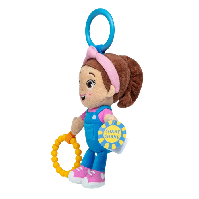 Plush Ms. Rachel doll in blue overalls and pink headband holding a yellow beaded ring with a blue hanging clip.