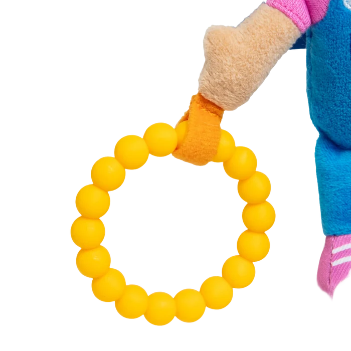 Yellow beaded ring attached to a plush doll arm with an orange fabric loop.