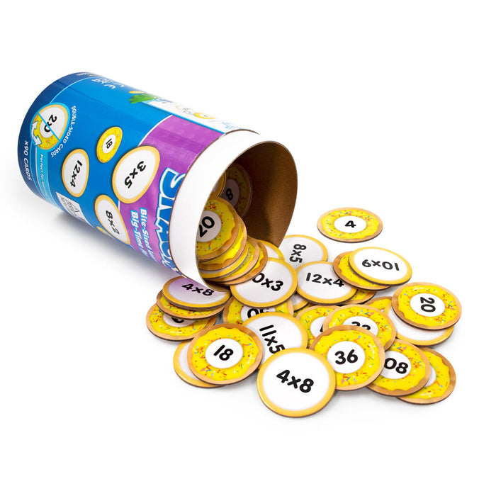 Blue tube container spilling round yellow donut-themed multiplication cards with math problems and numeric answers.