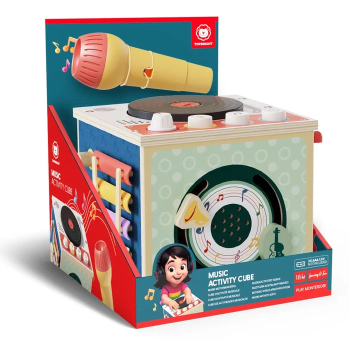 Pastel wooden toy cube with a turntable, microphone, and xylophone, shown in red and blue retail packaging.