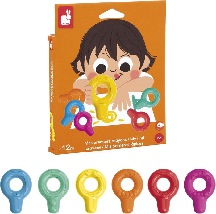 Six colorful, ring-shaped crayons with smiley faces displayed below orange packaging showing a child drawing.