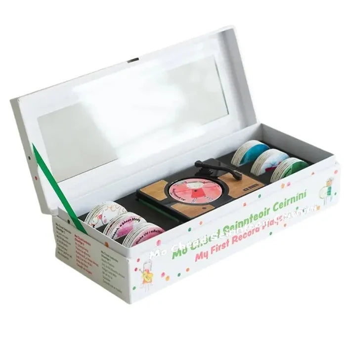 Open white toy box featuring a wooden-style record player, colorful illustrated discs, and an inner lid mirror.