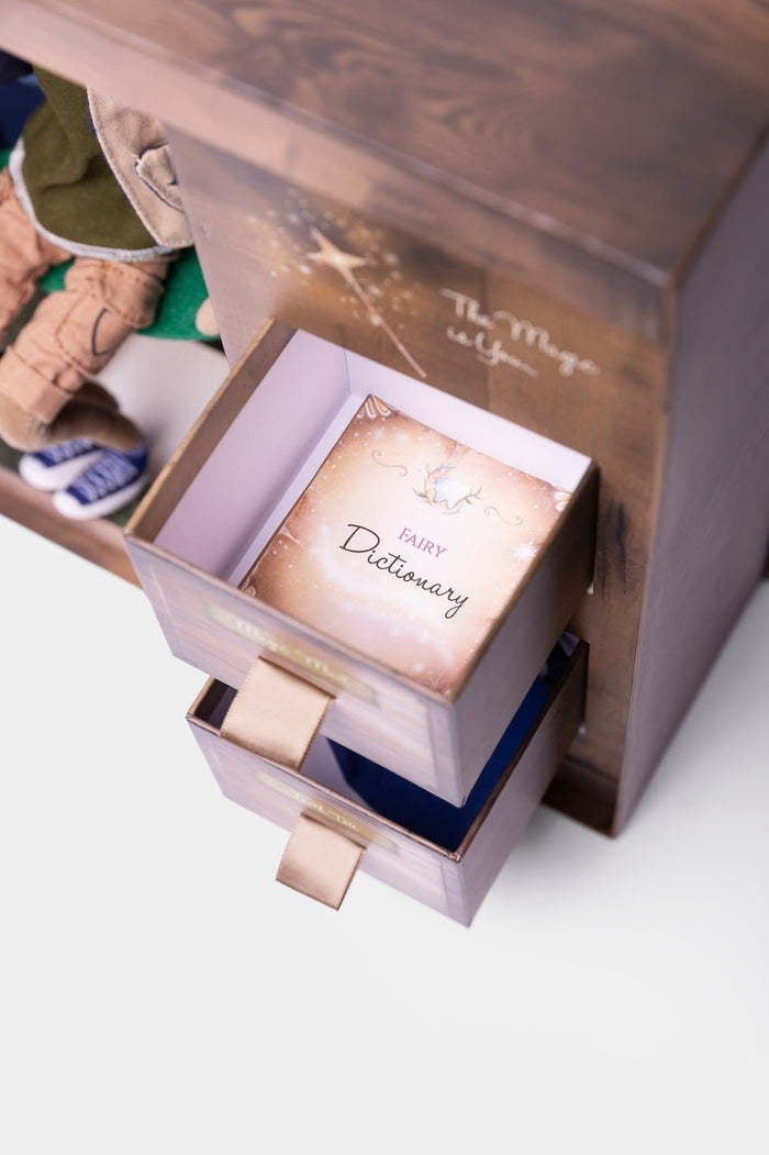 Wooden gift box with open drawers revealing a Fairy Dictionary book and a boy tooth fairy doll.