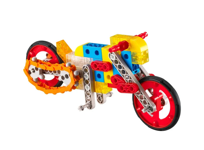 Toy motorcycle built with red, blue, and yellow plastic gears and blocks, featuring large red wheels and an orange chain.