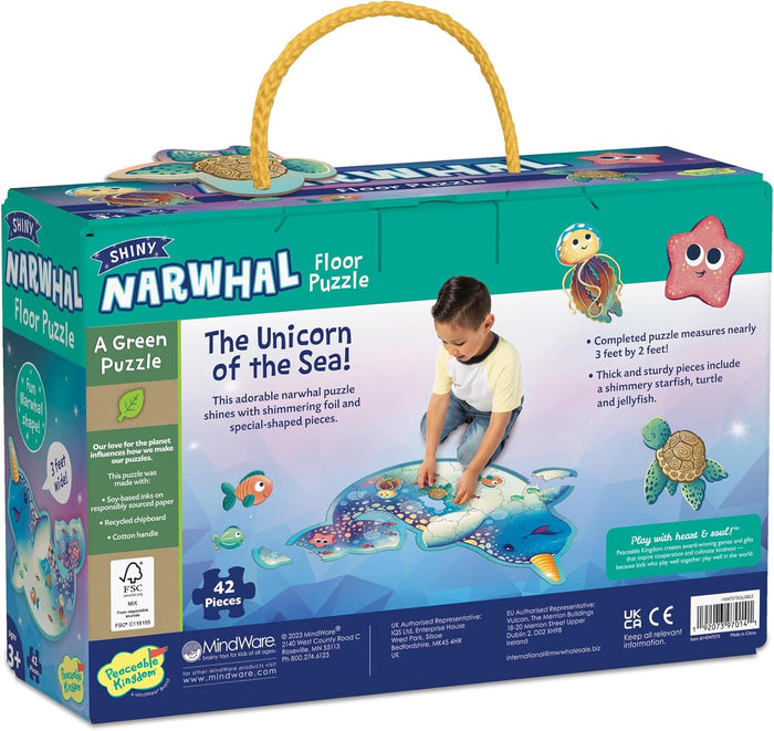 Teal box with yellow rope handle shows a child assembling a narwhal-shaped floor puzzle with colorful sea animal art.