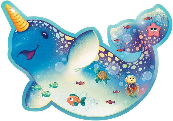 Blue narwhal-shaped floor puzzle with an orange tusk, sea turtle, jellyfish, and starfish in a colorful sea scene.