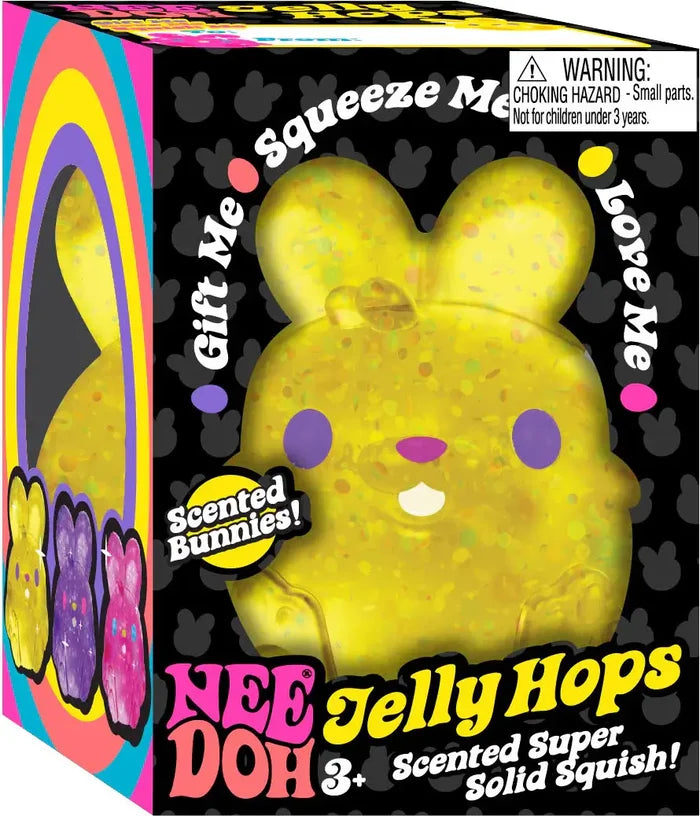 Yellow bunny-shaped squeeze toy with purple eyes and colorful specks in a black decorative display box.