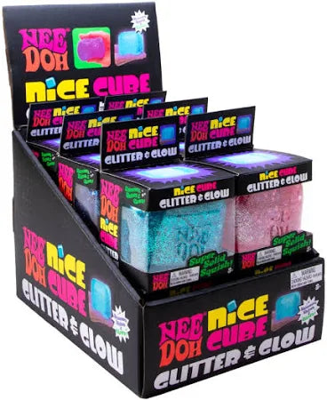 Display box of squishy teal and pink glitter cubes in black packaging with neon pink and yellow text.