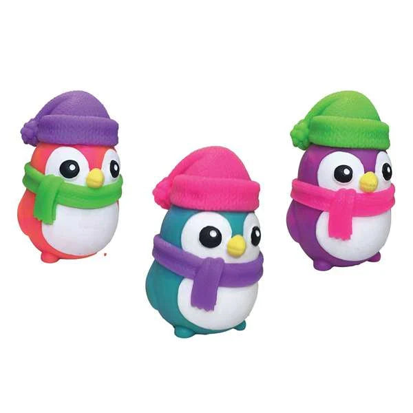 Three round penguin squishy toys in pink, teal, and purple wearing colorful pom-pom hats and matching scarves.