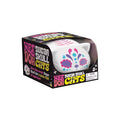 White cat squishy with colorful sugar skull face art, in a black display box with vibrant pink and yellow text.