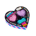 Three sparkly pink, purple, and teal heart-shaped fidget toys displayed in a heart-shaped striped window box.