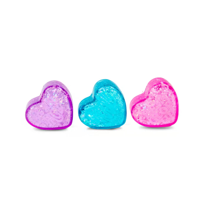 Three translucent, glittery heart-shaped fidget toys in purple, bright blue, and pink.