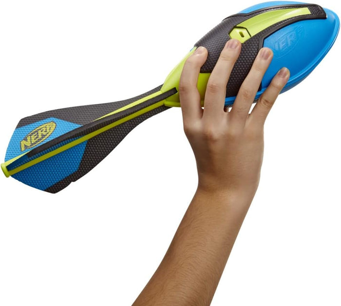 Hand holding a blue and lime green Nerf foam football with black textured grip and three stabilizing tail fins.