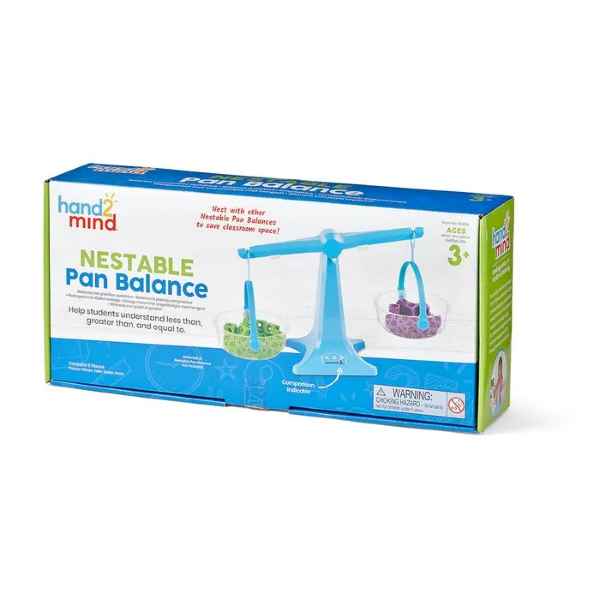 Blue plastic toy pan balance with clear buckets, shown on its white and blue hand2mind product packaging.